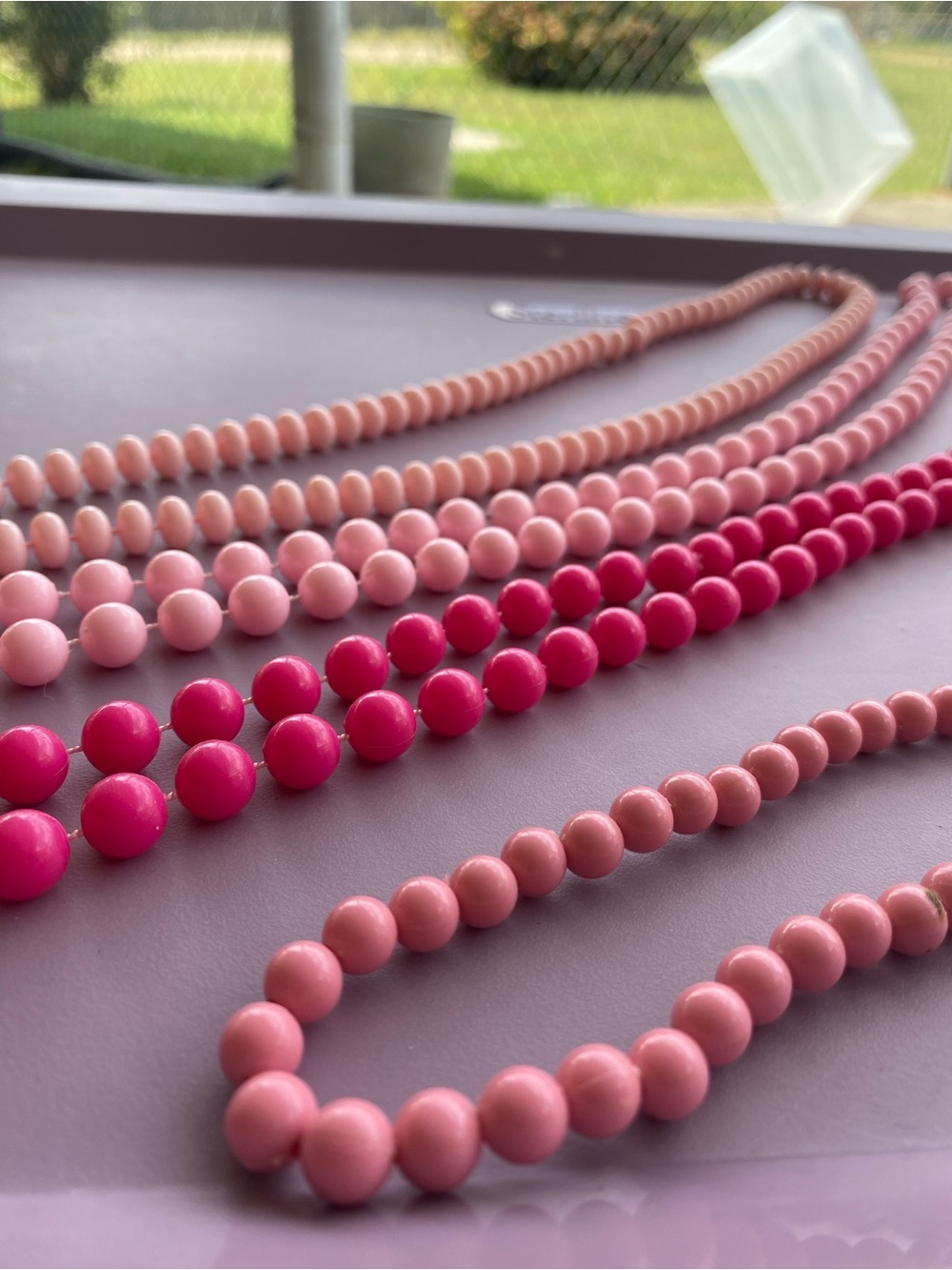 Set of 4 pink beaded necklaces, different lengths